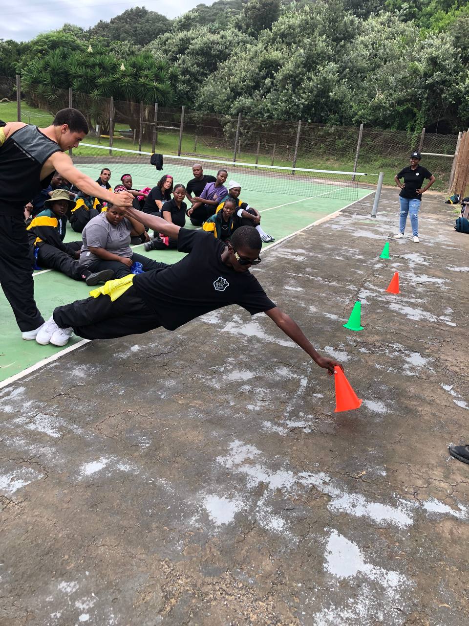 A participant reaching for a marker during an MGA agility challenge