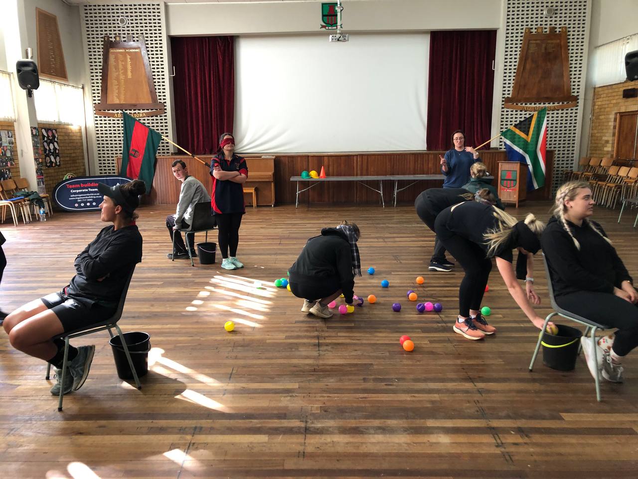 Adult participants completing a colourful indoor team-building challenge